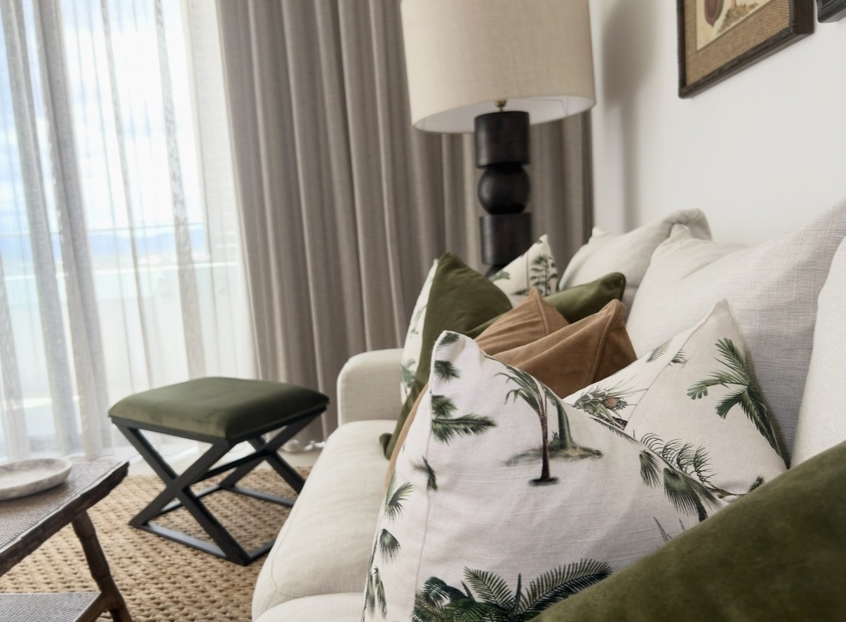 Styled sofa with layered cushions and considered textiles by SAGE